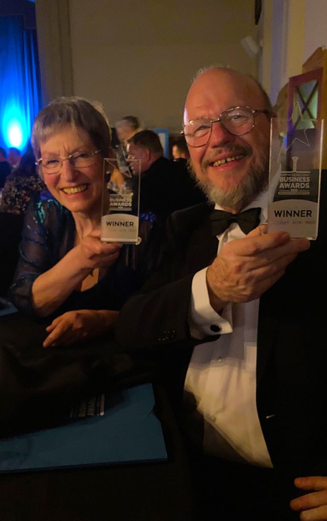 Yvonne and Dave holding awards.